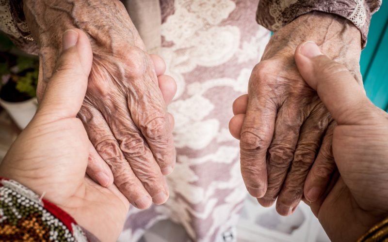 Woman taking care of elderly lady